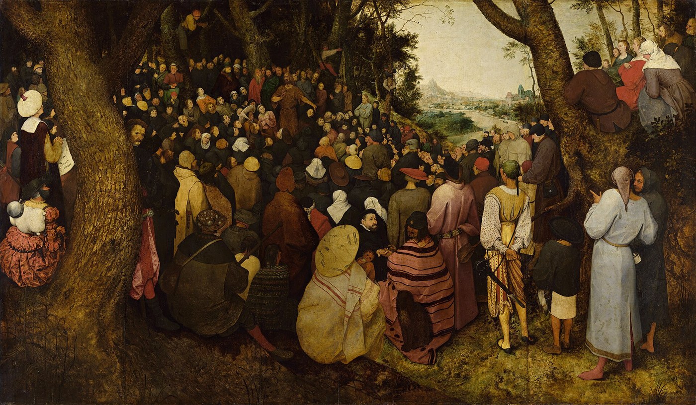 A large crowd seated among trees listening to a preacher, while in the foreground a well-dressed man holds out his palm to have his fortune told
