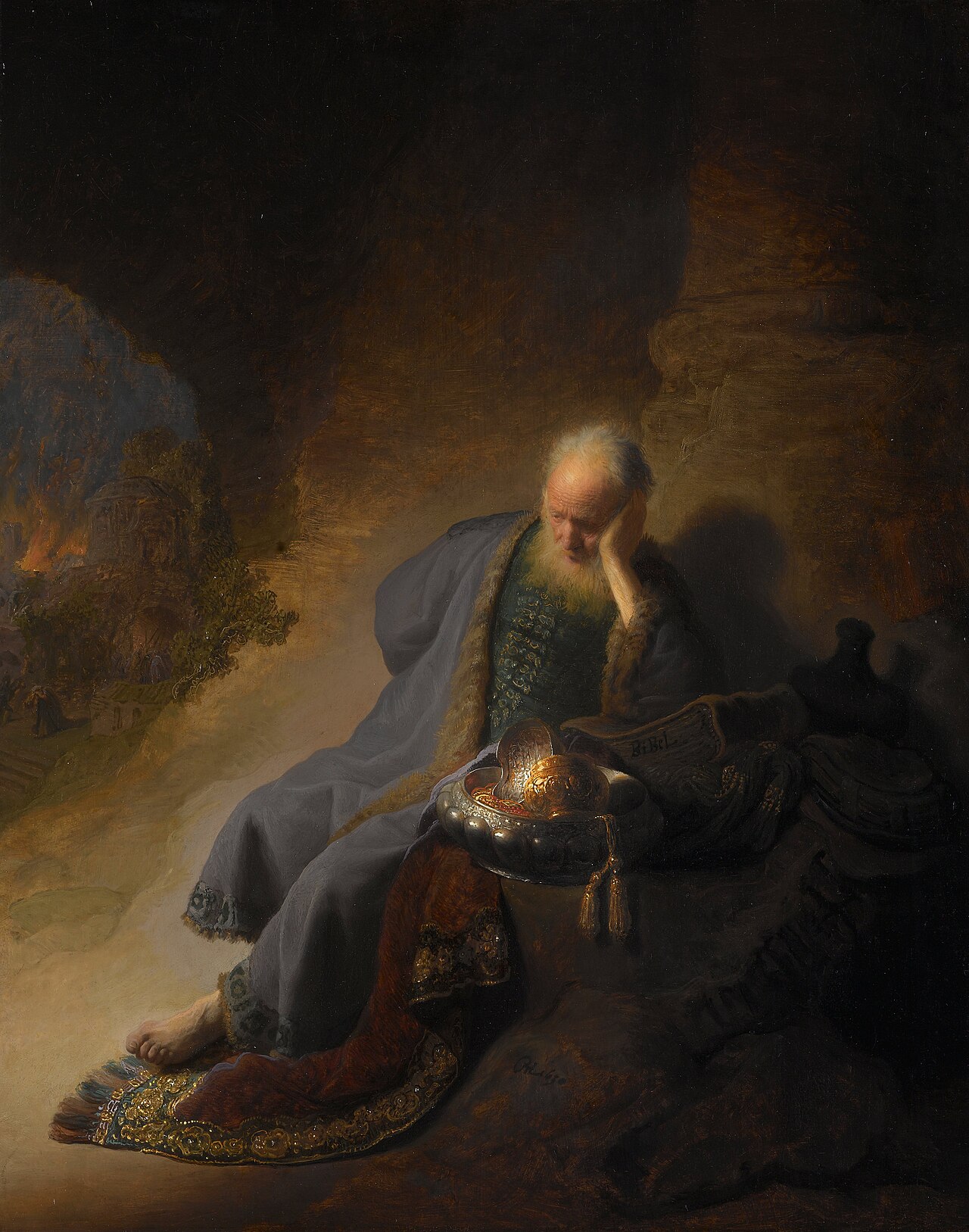 An aged prophet sits with his head resting on his hand, mourning, while the city behind him burns in the distance