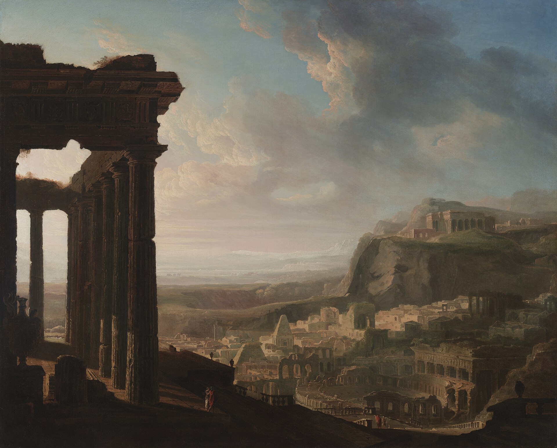 Two small figures stand among broken columns above a vast ruined city stretching away to the hills