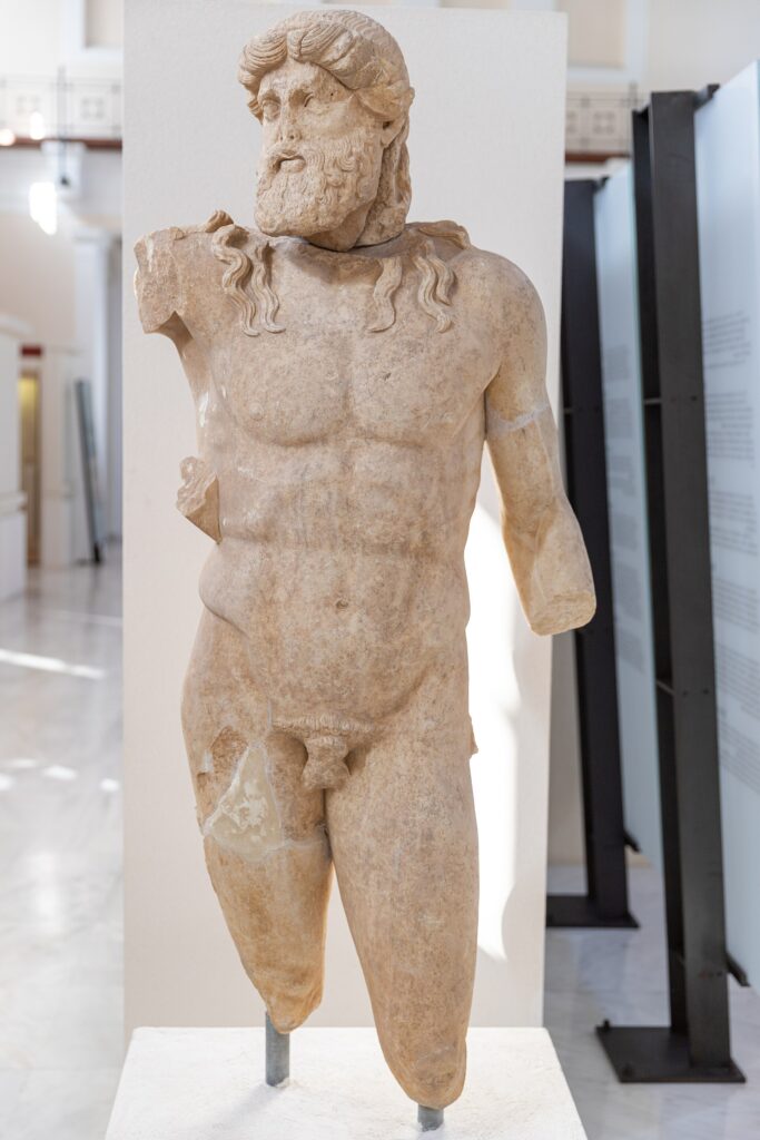 An ancient marble statue of Zeus in the Archaeological Museum of Olympia, Greece