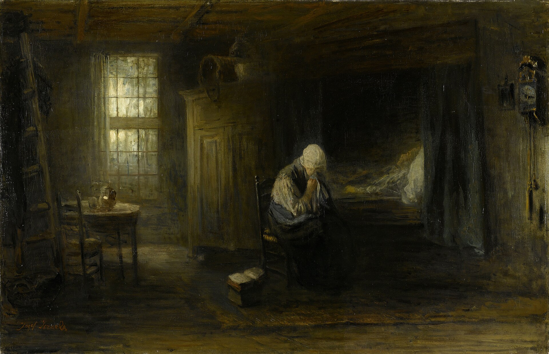 In a dim cottage room lit by a single window, an elderly woman in a white cap sits bowed in grief beside the curtained box-bed where her husband lies still, a book set down at her feet