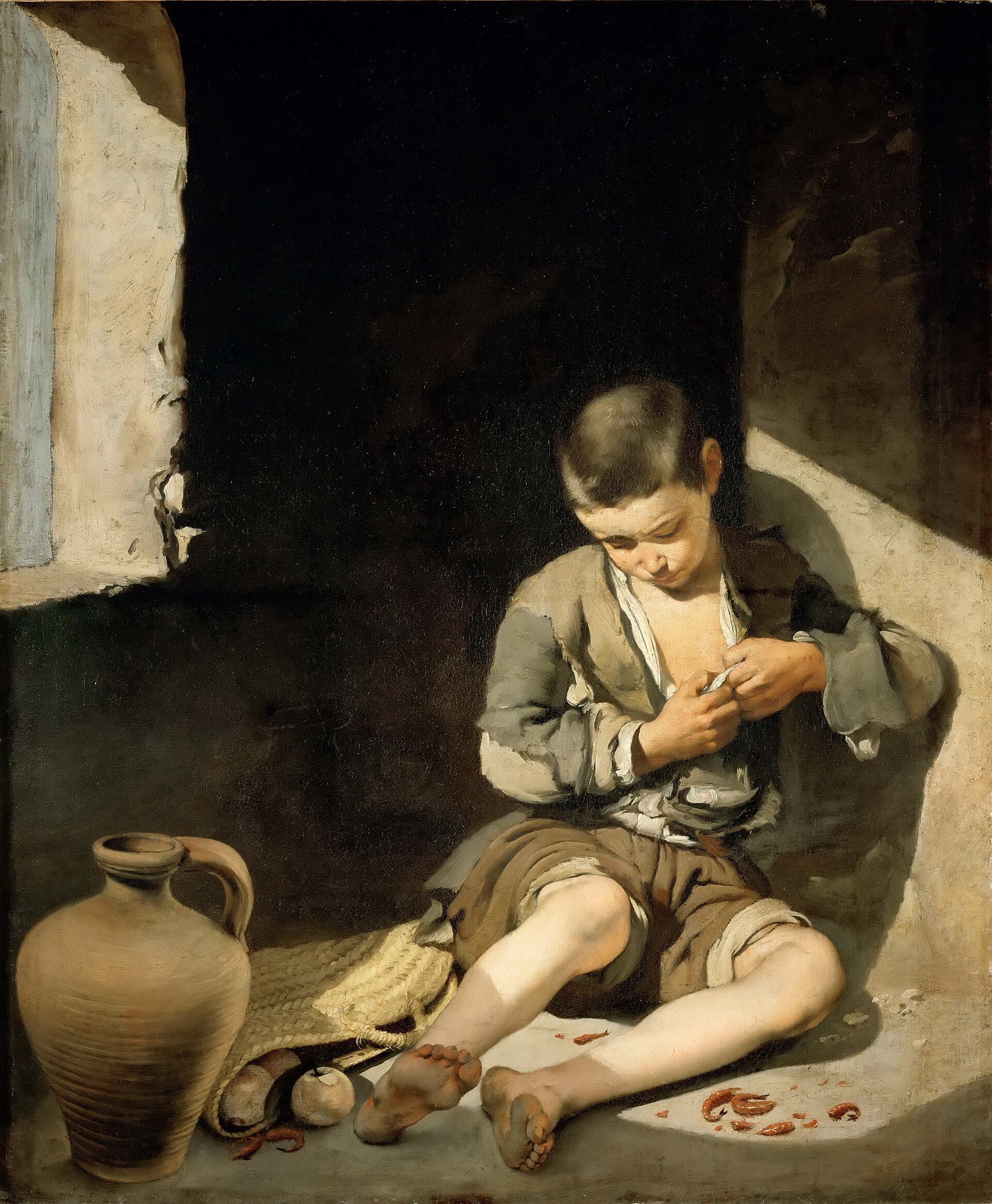 A ragged barefoot boy sitting alone on the floor of a bare room in a shaft of sunlight, picking at his clothes, with an earthen jug and a few scraps of food beside him