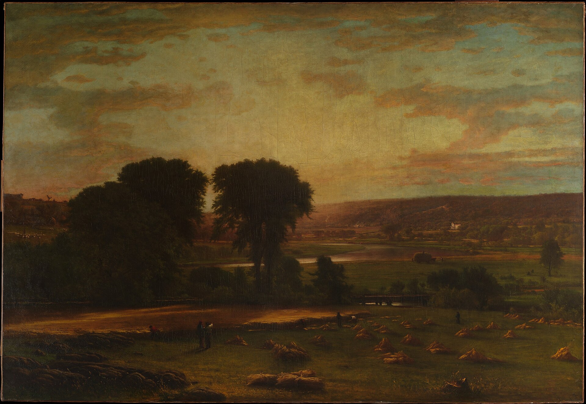 Inness's painting of a wide river valley at golden evening, with harvesters among sheaves of grain beneath great trees