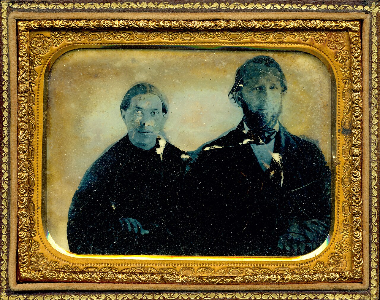 An early ambrotype in a gilded case showing a young Ellen White seated beside her husband James White, both dressed in dark clothing