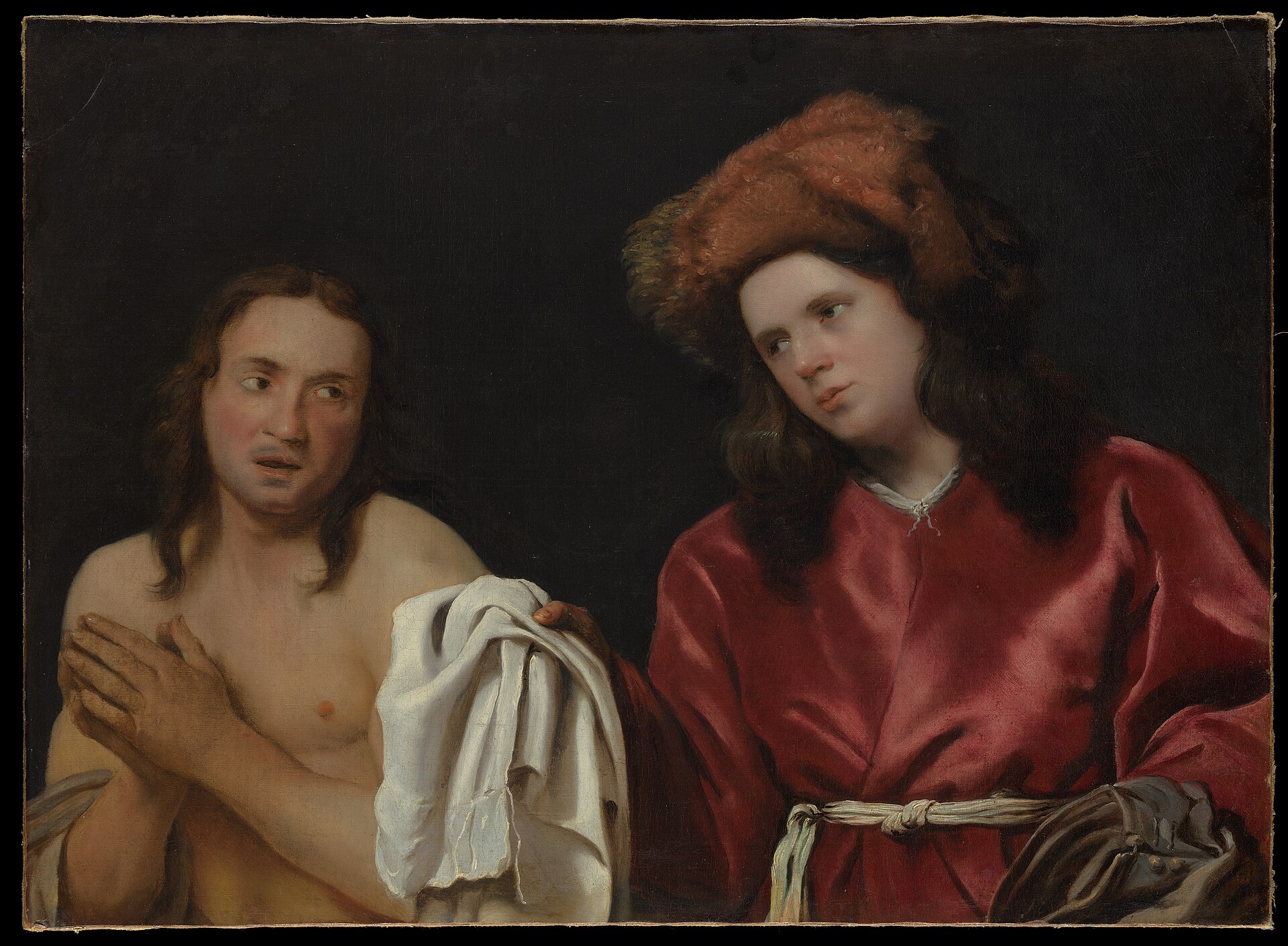 A young man in a red robe hands a white linen garment to a poor, bare-shouldered man who clasps his hands in gratitude
